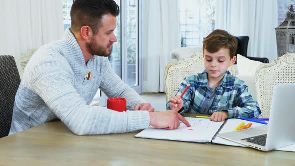 Father helping his son with homework 4k