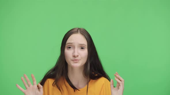 Portrait of a Frightened Young Girl Banging Her Palms on the Glass Calling for Someone and Asking