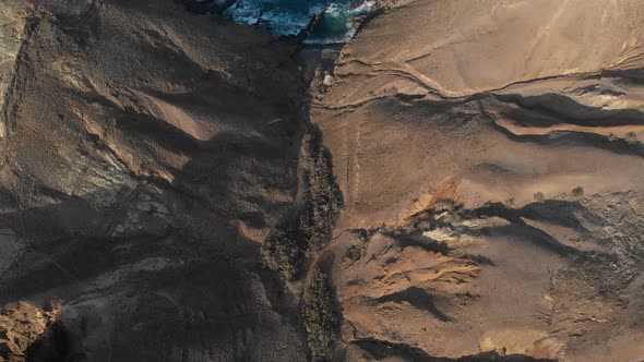 God's eye view of waves crashing on northside cliffs. Porto Santo island.