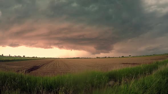 Time lapse of extreme supercell storm clouds swirling in the sky with lightning