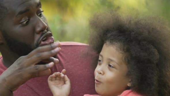 Cute Little Girl Playing With Her Smiling Father Outside, Laughing and Hugging