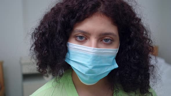 Closeup Exhausted Face of Tired Doctor in Coronavirus Face Mask Looking at Camera