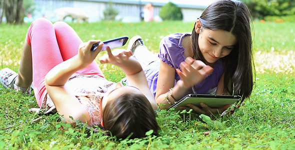 Girls Having Fun on Digital Tablet and Smartphone 