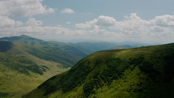 Aerial Drone View. Green Mountains Without Trees, Lake Dogyaska in the Mountains on a Background of