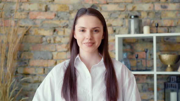 Young Positive Businesswoman Looking at Camera and Smiling