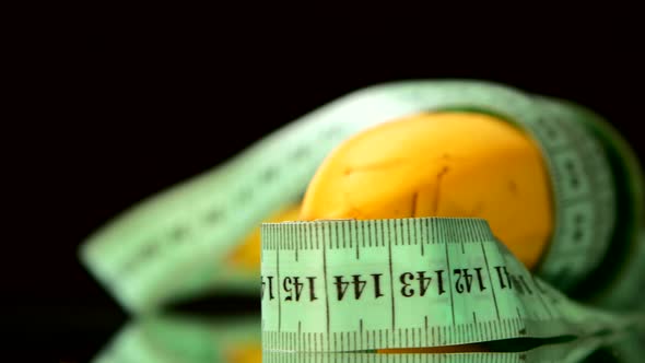 Apple Collection with Measuring Tape, Rotation, Reflection, on Black, Close Up