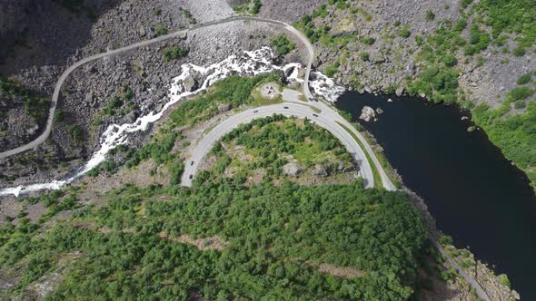 Crazy good descending aerial over Mabodalen mountain road leading to Hardangervidda national park No