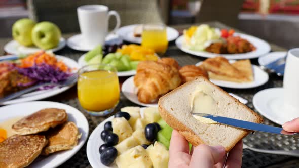 Woman Hands Spreading Butter On Toasted Bread Having Breakfast