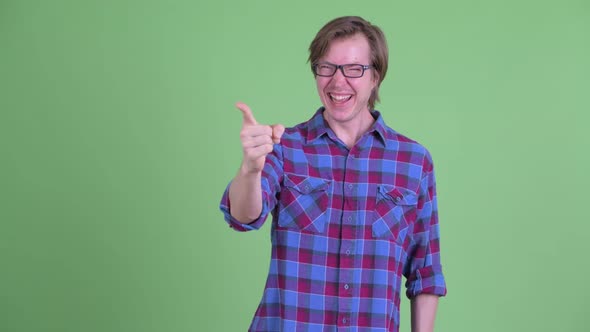 Happy Young Hipster Man Laughing and Pointing Finger
