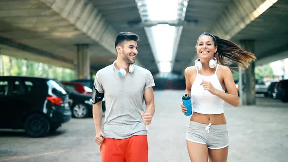 Attractive Man and Beautiful Woman Jogging Together