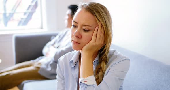 Man and woman upset with each other in living room