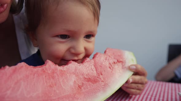 Young Mom with Daughter Eat Watermelon at Home