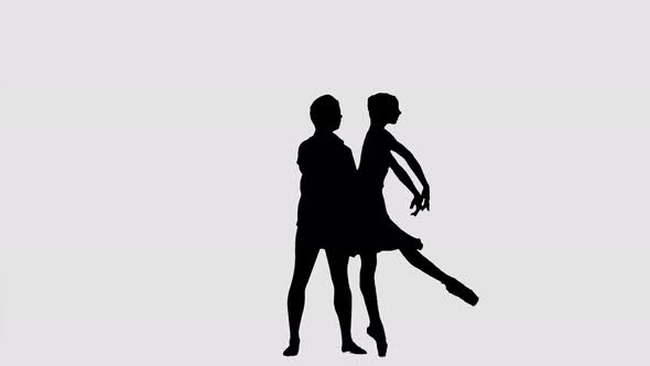 Silhouette Professional Ballet Pair Practicing Moves on Dark Stage