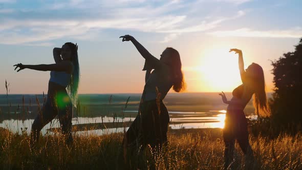 Aerobics in Nature - Three Young Women Dancing on Sunset