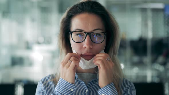 A Lady Is Putting on a Safety Mask in a Front View