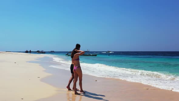 Guy and girl happy together on paradise sea view beach lifestyle by turquoise sea and white sand bac