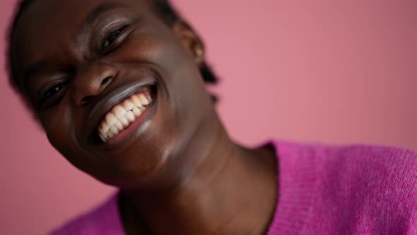 Positive woman volunteer waving at the camera and pointing at the copyspace