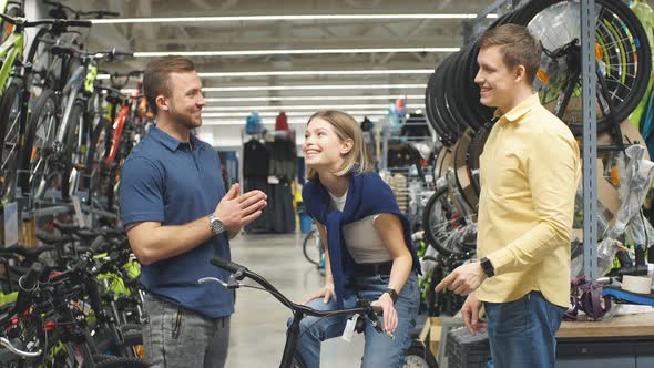 Pleasant Salesman Try To Sell Sportive Bicycle for Customers