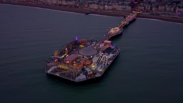 Brighton Seafront and Pier Illuminated at Night Aerial View