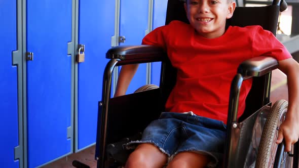Portrait of handicapped schoolboy sitting on wheelchair 4k