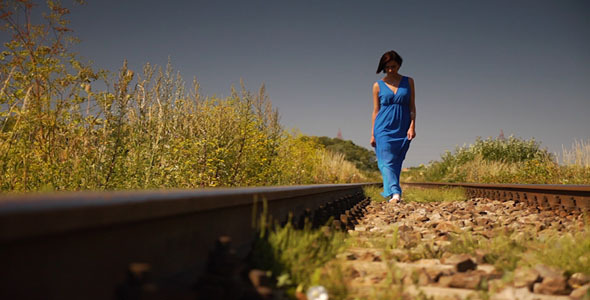 Girl Walking On Railroad