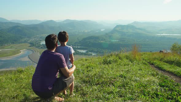 Portrait of Father with his son looking to the mountains