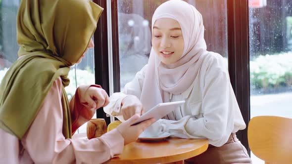 Young Asian Muslim Women Enjoying A Relaxing Moment in the Coffeeshop 04