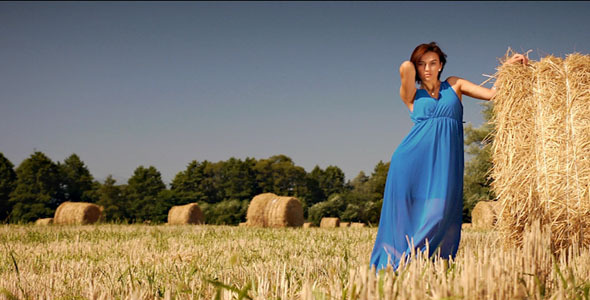 Girl Walking In Hay Field