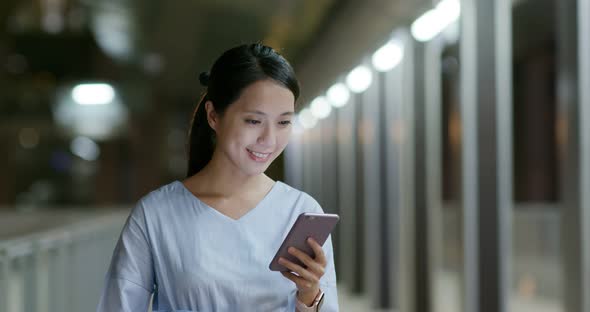 Woman work on cellphone at night