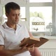 The man is intently flipping through the pages of an old book and reading it - VideoHive Item for Sale