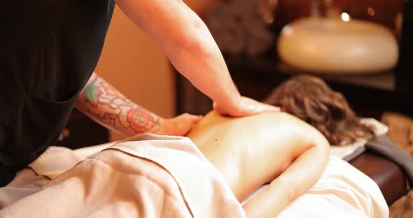 Woman Receiving Back Massage in Spa