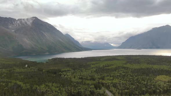 View of Scenic Lake Surrounded By Forest and Mountains