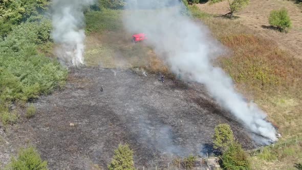 Controlled fire on meadow. Drone day footage