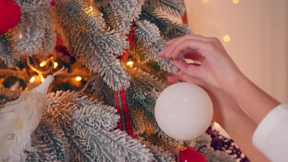 Girl Decorates the Christmas Tree Close Up