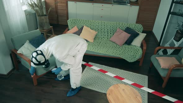 Disinfection of Furniture Is Being Done By a Person in a Hazmat Suit. Disinfecting Process During