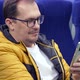 Guy in Eyeglasses Looking Social Media Texting Messages Using Cell Phone While Riding Home By Train - VideoHive Item for Sale