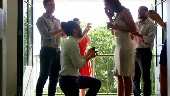 Man proposing woman with ring by kneeling down