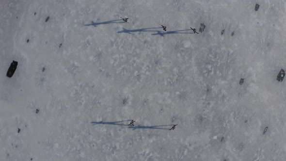 Group of young women firgure skating on frozen lake