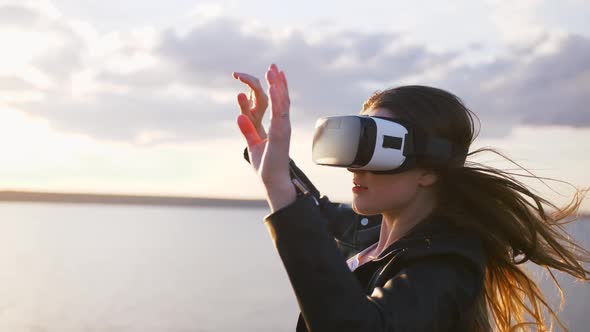 Portrait of Young Woman in Vr Glasses Outdoors with Beatiful Sea Sunset Background Slow Motion