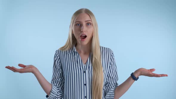 Blonde Young Woman Saying "I Don't Know" and Spreading Her Hands to the Sides