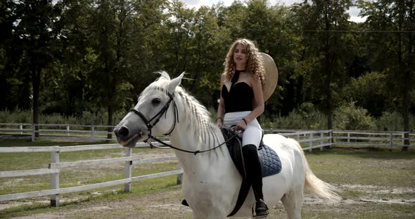 Young Pretty Jockey Rides A Horse