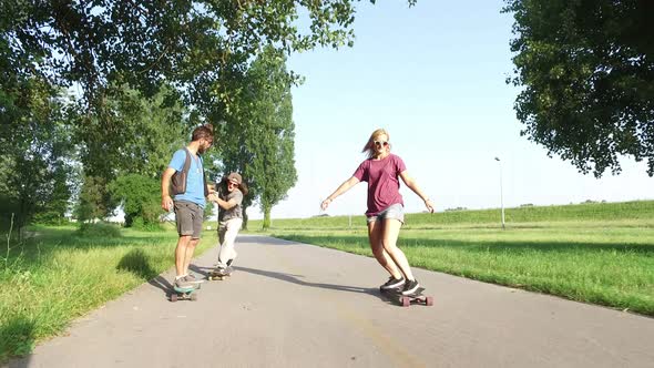 Three cool friends having fun skateboarding