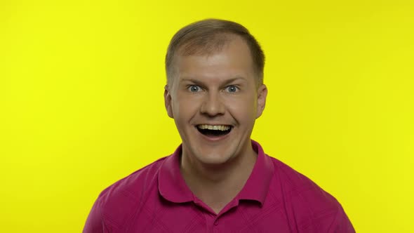 Portrait of Caucasian Man Posing in Pink T-shirt. Amazed Handsome Guy Shocked, Surprised, Say Wow