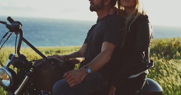 Couple on Motorcycle Watching the Sunset