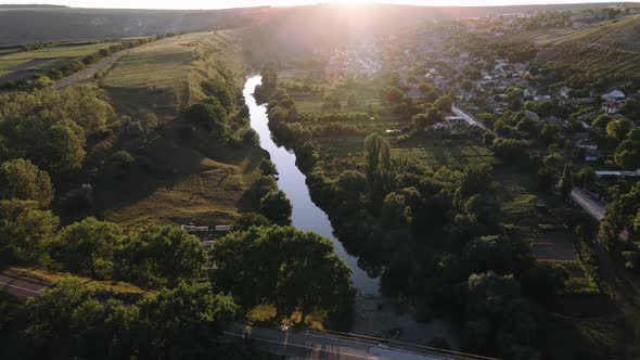 Aerial View of a Beautiful River That Crosses a Small Village on a Natural Trail in the Forests of