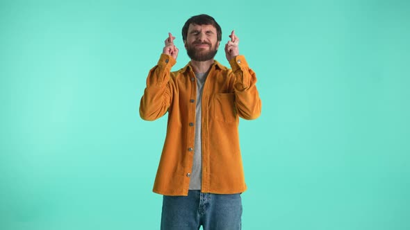 Bearded Male Keeping His Fingers Crossed for Luck