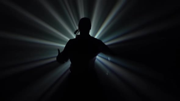 Bottom View of a Black Silhouette of a Guy Moving in the Style of Street Break Dance and Hip Hope