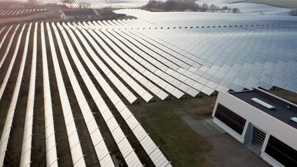 Drone Flight Over Sunlit Solar Panels In Countryside