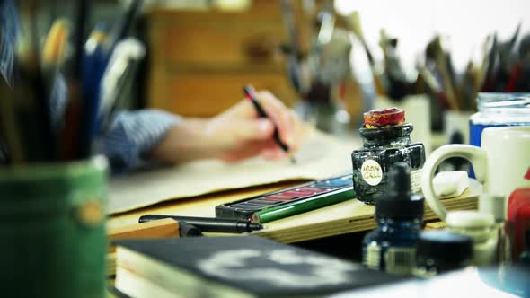 Artist drawing at desk