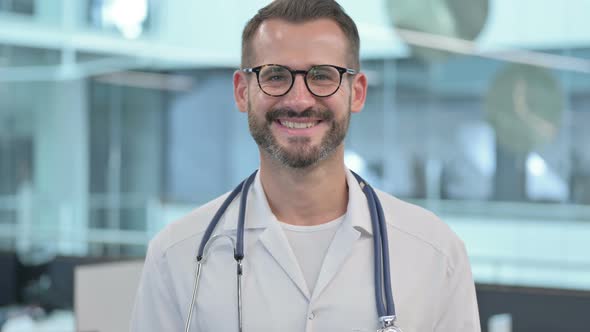 Middle Aged Male Doctor Smiling at the Camera